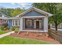 Charming craftsman-style home with a covered front porch, landscaped yard, and inviting curb appeal at 588 Angier Ne Ave, Atlanta, GA 30308