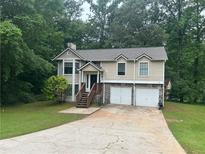 Charming two-story home features a well-maintained lawn and an attached two-car garage at 3951 Mcgill Dr, Decatur, GA 30034