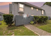 Charming townhome featuring a fenced entrance and low maintenance landscaping at 556 Country Greens Dr, Jonesboro, GA 30238