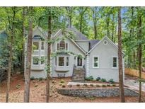 Charming home with beautiful landscaping, stone accents, and mature trees at 1183 Woods Ne Cir, Atlanta, GA 30324