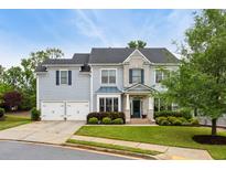 Charming two-story home with a well-manicured lawn, two-car garage, and welcoming front porch at 3909 Obryant Se Cir, Smyrna, GA 30082