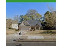 Charming one-story home with mature trees, attached garage, and well-maintained landscaping at 222 Yardsley Dr, Mcdonough, GA 30253