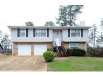 Charming split-level home featuring stone accents, two-car garage and a welcoming entrance staircase at 3674 Riverchase Ter, Decatur, GA 30034