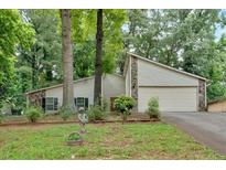 Two-story home featuring stone accents, an attached two-car garage, and a well-manicured front yard at 3902 Cedarwoods Way, Lawrenceville, GA 30044