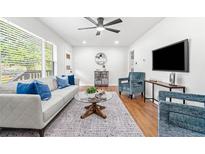 Bright living room with hardwood floors, modern furniture, and a large window at 801 N Evelyn Nw, Atlanta, GA 30318
