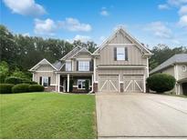 Charming two-story home featuring a well-manicured lawn and a convenient two-car garage at 200 Pine Trl, Dallas, GA 30157