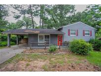 Charming single-Gathering home with a carport and red front door and gray trim at 2475 Harvel Nw Dr, Atlanta, GA 30318