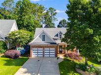 Charming brick-and-siding home with well-manicured landscaping, and a two-car garage at 81 Richmond Way, Villa Rica, GA 30180