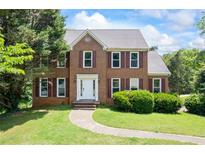 Charming brick home with well-maintained landscaping and a welcoming front entrance at 2196 Kildare Nw Way, Kennesaw, GA 30152