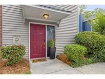 Charming front entrance with a vibrant red door and well-manicured landscaping at 812 Dixie Ne Ave, Atlanta, GA 30307