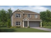 Charming two-story home with brick facade, gray shutters, manicured lawn and two car garage at 1209 Arnhem Dr, Hampton, GA 30228