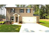 Charming two-story home with a fresh lawn and convenient two-car garage at 45 Emerald Ln, Covington, GA 30014