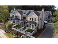 View of townhomes featuring manicured lawns, covered entryways and beautiful landscaping at 160 Chiswick Cir # 2, Alpharetta, GA 30009