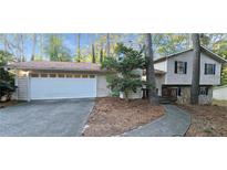 Charming home featuring a two-car garage, classic siding and a cozy front porch at 3226 Bruckner Blvd, Snellville, GA 30078