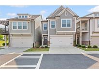 Charming townhome featuring an attached garage and craftsman style architectural details at 323 Hayden Circle Cir, Woodstock, GA 30189