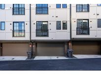 Modern townhouse exterior featuring attached garages and black-framed windows at 77 Krog Ne St, Atlanta, GA 30307