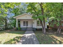 Charming single-story home with a covered porch and mature trees in the front yard at 2988 E Point Pt, East Point, GA 30344