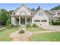 Charming two-story home with a covered front porch, manicured lawn, and two-car garage, perfect for suburban living at 515 Saint Barbaras Nw Ln, Marietta, GA 30064
