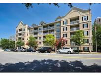 Attractive four-story condo building with balconies, well-kept landscaping, and street parking at 1075 Peachtree Walk # A205, Atlanta, GA 30309