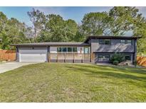 Charming home with a modern exterior, featuring a well-manicured lawn and a convenient attached garage at 2344 Belmont Dr, Decatur, GA 30032