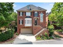Charming brick home featuring a well-manicured lawn and a two-car garage at 1029 Fairway Ne Ests, Atlanta, GA 30319