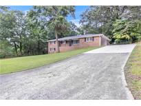 Charming brick home featuring a long driveway and well-manicured lawn at 6243 David Sw Ln, Mableton, GA 30126