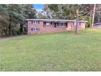Charming brick home with well-manicured lawn and mature trees at 6243 David Sw Ln, Mableton, GA 30126