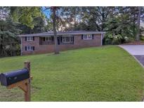 Charming brick home featuring a well-manicured lawn and a classic mailbox at 6243 David Sw Ln, Mableton, GA 30126