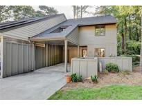 Inviting exterior of home with attached carport, landscaping, and neutral toned siding at 882 Cedar Canyon Se Sq, Marietta, GA 30067
