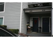 Charming townhouse exterior featuring dual entrances and neutral gray siding with white trim at 1026 Riverbend Club Se Dr, Atlanta, GA 30339