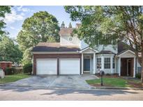 Charming townhome with a two-car garage and a well-manicured lawn at 2594 Laurel Nw Cir, Atlanta, GA 30311