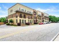 Charming townhomes with brick and tan exteriors line the street, offering urban living at its finest at 384 16Th Nw St # 1, Atlanta, GA 30363