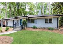 Charming one-story home with a well-manicured lawn and inviting entrance at 1443 Fama Ne Dr, Atlanta, GA 30329