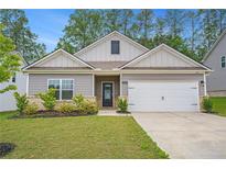 Charming single-story home featuring a two-car garage, manicured lawn, and welcoming gray siding at 225 Limestone Cir, Conyers, GA 30013