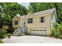 Two-story home with neutral siding, shutters, a covered entryway, and attached garage at 540 Alcovy Hills Dr, Lawrenceville, GA 30045