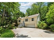Charming two-story home with a well-manicured lawn and an attached garage, surrounded by lush trees at 540 Alcovy Hills Dr, Lawrenceville, GA 30045