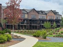Beautiful brick townhomes with manicured landscaping and walking paths at 435 Chiswick Cir # 21, Alpharetta, GA 30009