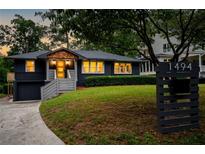 Beautiful craftsman home featuring a dark gray paint, wooden shingles, and a well manicured lawn at 1494 May Se Ave, Atlanta, GA 30316