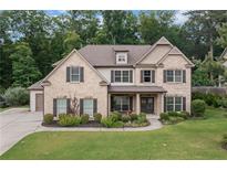 Charming two-story brick home with a well-manicured lawn and inviting curb appeal at 4460 Hunters Walk Way, Cumming, GA 30028