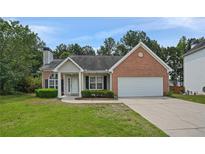 Charming single-story brick home with an attached garage and a well-maintained front yard at 3025 Andora Sw Dr, Marietta, GA 30064