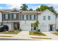 Charming townhomes featuring manicured lawns and driveways leading to attached one-car garages at 3481 Lakeview Crk, Lithonia, GA 30038