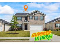 Charming two-story home with a well-manicured lawn and a two-car garage in a suburban neighborhood at 2296 Waycross Ln, Dacula, GA 30019
