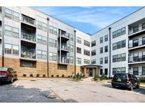 Condominium building with brick facade, multiple balconies and parking lot in front at 898 Oak Sw St # 3420, Atlanta, GA 30310