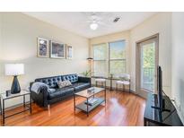 Bright living room boasts hardwood floors, modern furnishings, and natural light from large windows at 898 Oak Sw St # 3420, Atlanta, GA 30310