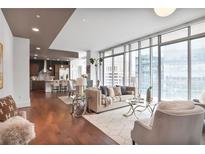 Bright living room with floor-to-ceiling windows and open concept kitchen and dining area at 1065 Peachtree Ne St # 3505, Atlanta, GA 30309
