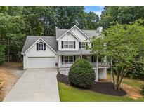 Charming two-story traditional home with a well-manicured lawn and attached two-car garage at 2990 Cove Crossing Dr, Lawrenceville, GA 30045