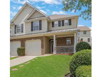 Charming two-story home with a well-manicured lawn, brick accents, and an attached garage at 417 Red Coat Ln, Woodstock, GA 30188
