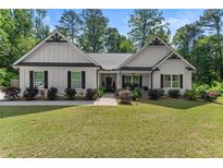 Charming one-story home with a well-manicured lawn, attractive landscaping, and inviting front porch at 2751 Pilgrim Mill Rd, Cumming, GA 30041