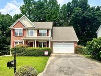 Charming two-story home with brick facade, well-maintained lawn, and an attached two-car garage at 5783 Poppy Tree Ln, Tucker, GA 30084