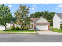 Charming one-story home with brick facade, manicured lawn, and two-car garage on a sunny day at 3589 Garden Manor Dr, Loganville, GA 30052